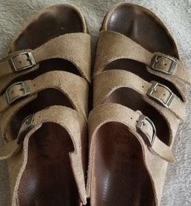 Three strap Birkenstock sandals.